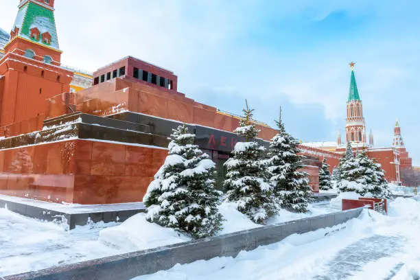 Photo of Moscow in snowy winter, Russia. Lenin`s Mausoleum by Moscow Kremlin on Red Square under snow. Mausoleum is a famous landmark of Moscow.