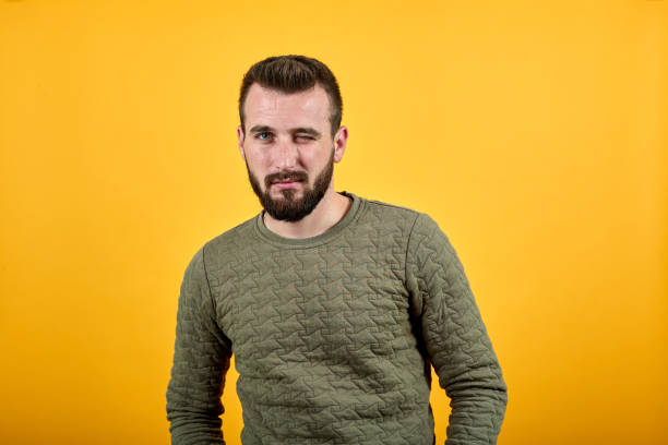 istock Handsome young caucasian man looking at camera, winks 1195206391