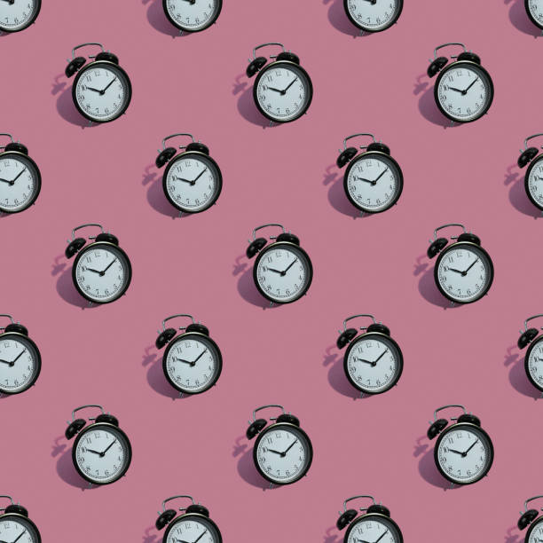 istock Many black classic style alarm clock isolated on pink background 1195206435