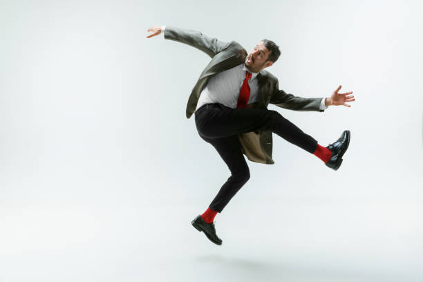 istock Young caucasian man moving flexible on white studio background 1195209424