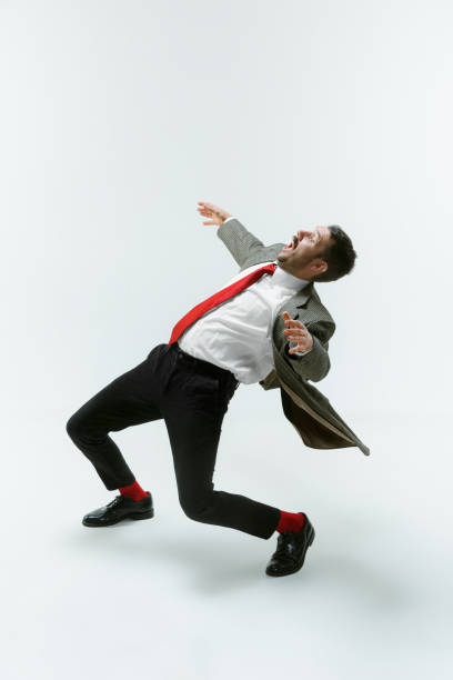 istock Young caucasian man moving flexible on white studio background 1195209431