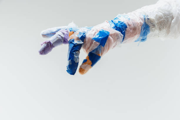 istock Big plastic hand made of garbage isolated on white studio background 1195209464