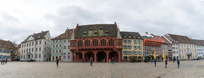 Freiburg, Baden-Wuerttemberg / Germany - 15. December, 2019: panorama view of historic guild houses on the Munsterplatz Square in the historic old city of Freiburg im Breisgau