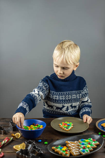 istock A child decorates cookies with icing 1195213644