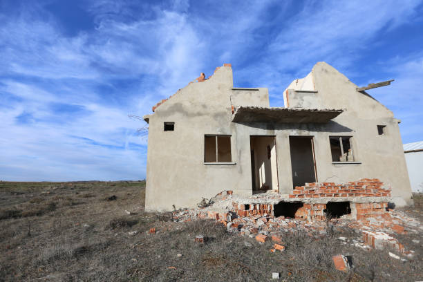 istock Old abandoned ruined house, red brick, white cloudy sky. Old broken house. 1195215236