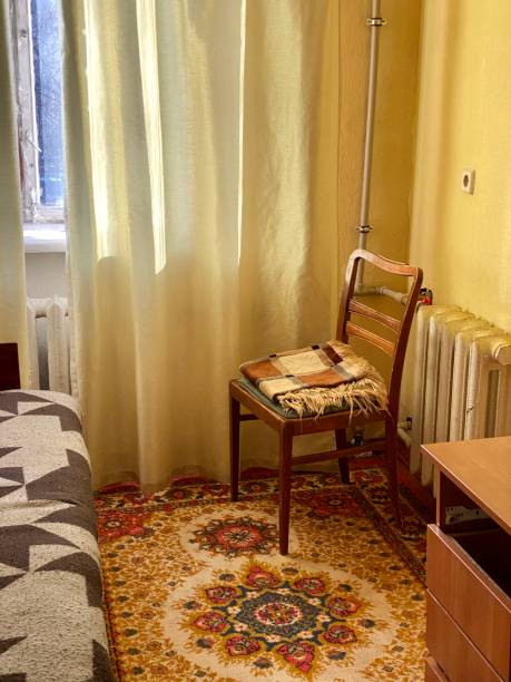 istock Soviet-style wooden chair and carpet 1195217625