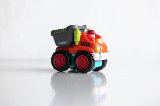 istock Plastic dump truck toy construction vehicle isolated on white background with reflection 1195219707