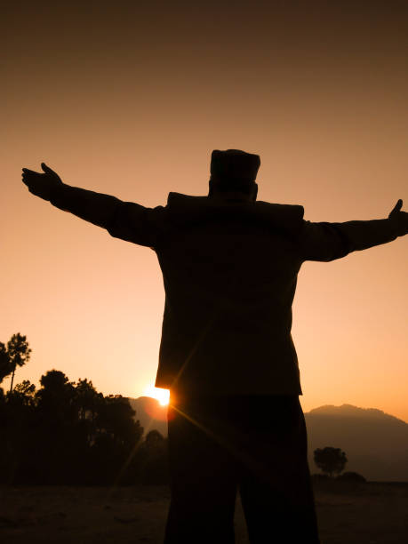 istock Silhouette of Himachali man standing with open arms. 1195220178