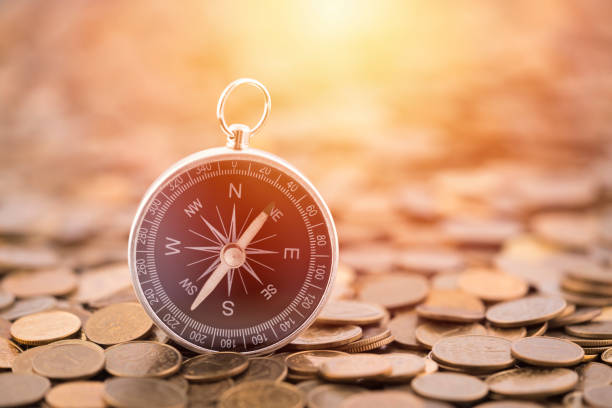 istock Financial concept with coins and compass 1195220228