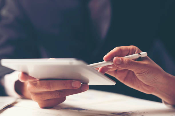 istock Cropped Image Of Business People Discussing Over Digital Tablet 1195222743