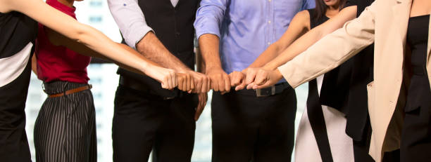 istock Midsection Of Office Colleagues Joining Hands 1195223724