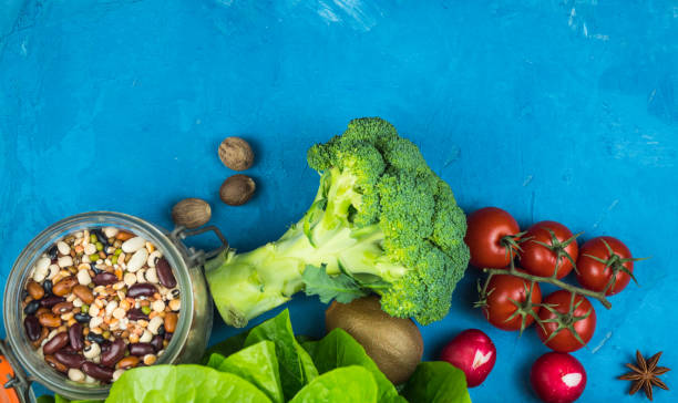 istock Cuisine - fresh colorful organic vegetables captured from above (top view, flat lounger). Blue background. Layout with free text (copy) space. vegan food. healthy food 1195227027