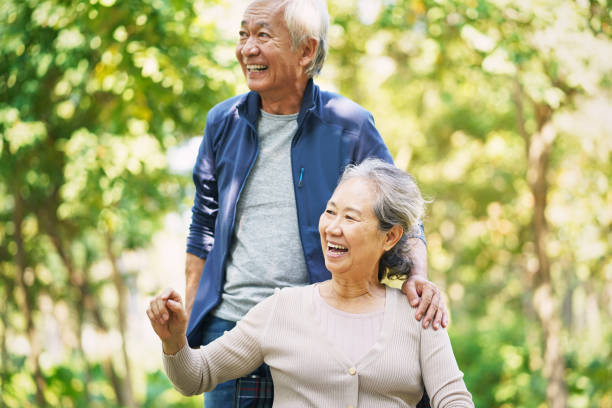 istock asian old couple relaxing outdoors in park 1195227588