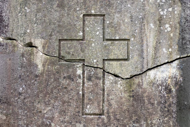 crack on the wall depicting a cross. stock photo