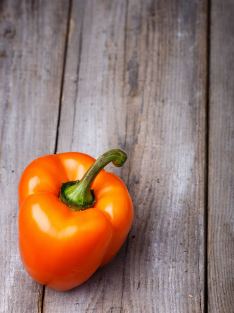 istock fresh orange pepper  on a rustic wooden background 1195231956