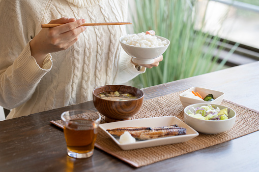 Hand of young woman eating breakfast