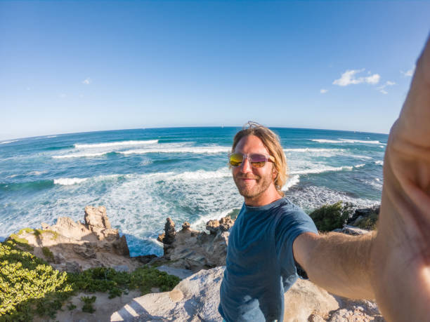 istock Man in Hawaii taking selfie by the coastline 1195233039