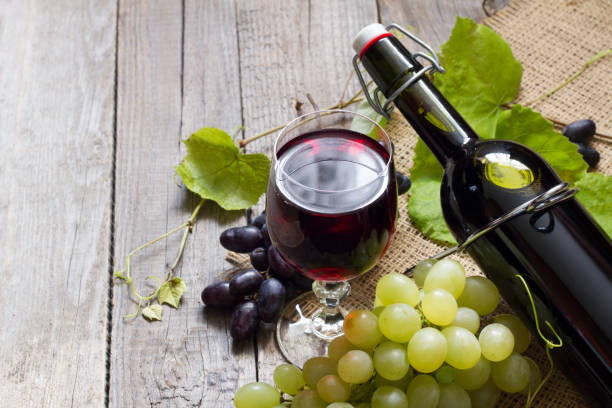 istock Homemade grape wine on old wooden background 1195233677