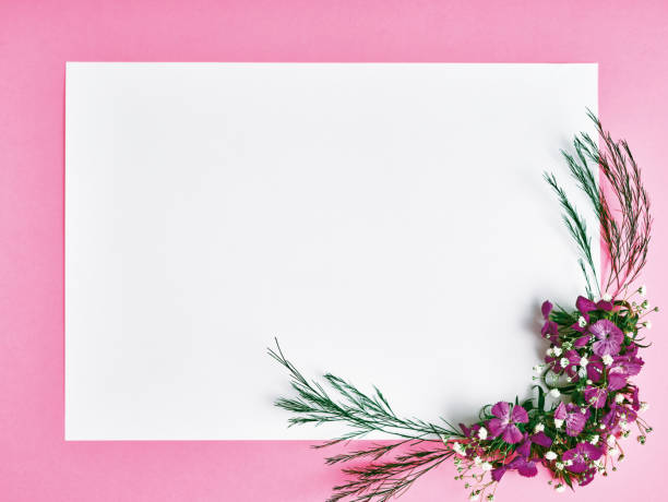 Bunch of roses and textured blank envelope isolated on white background. Studio shot.