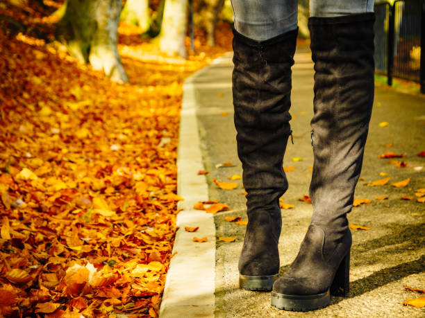 istock Woman wearing black knee high boots 1195234724