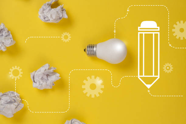 istock Creativity inspiration, great business idea concept with white light bulb and paper crumpled ball on yellow background. Flat lay, top view, copy space 1195234832