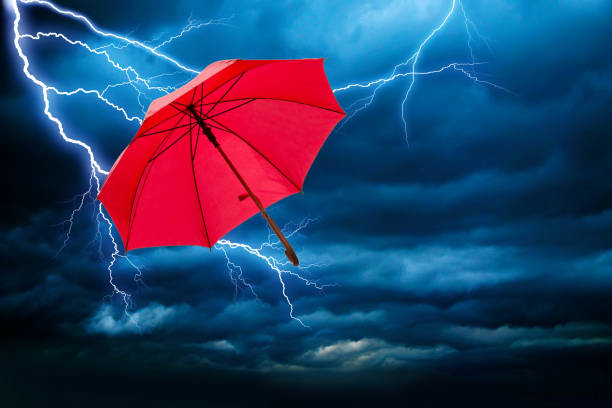 istock flying umbrella on a stormy day 1195239277