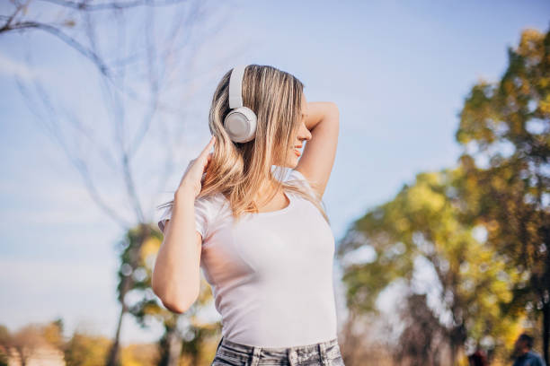 istock Happy young woman at the park 1195239849