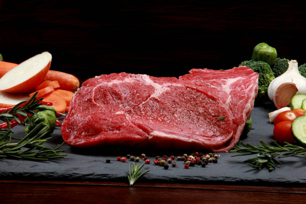 Marinated Fillet Steak on Slate Table surrounded by Vegetables ready for cooking Marinated Fillet Steak on Slate Table surrounded by Vegetables ready for cooking garlic bulb photos stock pictures, royalty-free photos & images