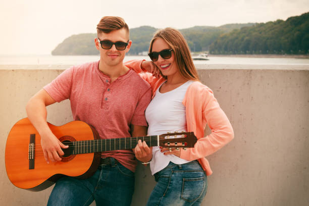 istock Happy couple with guitar outdoor 1195240575
