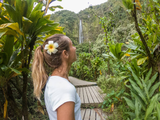 istock Young woman walking in tropical rainforest exploring nature 1195240970