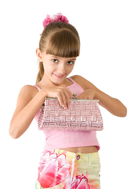 Variety of women's personal accessories organized in knolling arrangement on wooden background. Items include: clothing accessories, shoes, camera, bracelets, purse, scarf, wallet. Mother's Day or fashion themes.