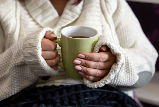 istock Female hands hold a mug with a hot drink. 1195242682