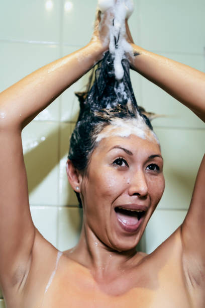 istock Naked Asian Woman Taking a Shower Bath 1195243589