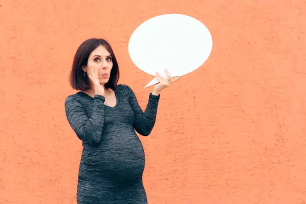 Photo of Pregnant Woman Holding Speech Bubble Making Announcement