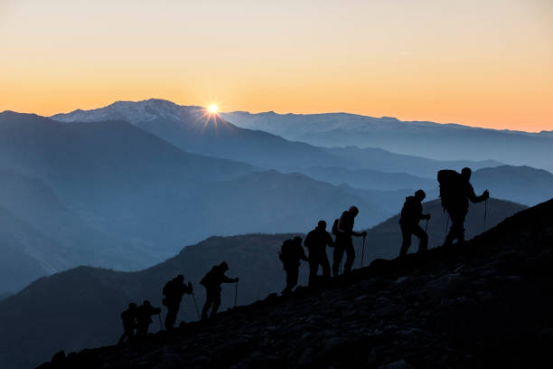 istock Silhouettes of hikers At Sunset 1195243808