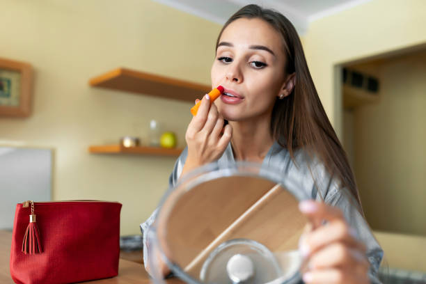 istock Beautiful Young Woman with a Lipstick 1195243814