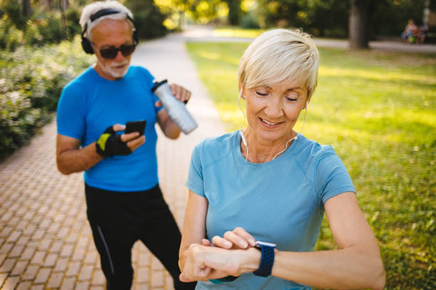 istock Senior woman using smart watch while exercising outdoors 1195243905