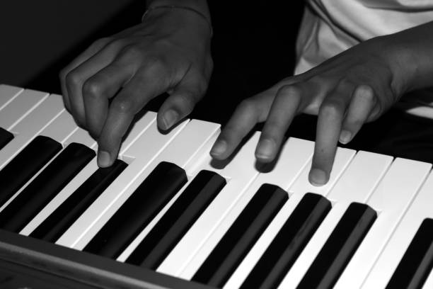 istock two hands playing music on the keyboard 1195243954