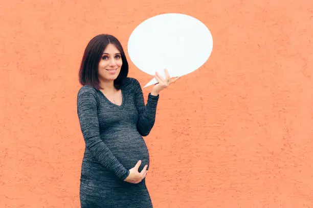 Photo of Pregnant Woman Holding Speech Bubble Making Announcement