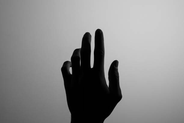 istock Silhouette hand black and white searching light help 1195245233
