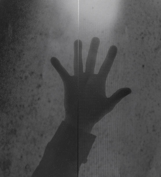 istock hand shadow on abstract dark transparent background 1195245237