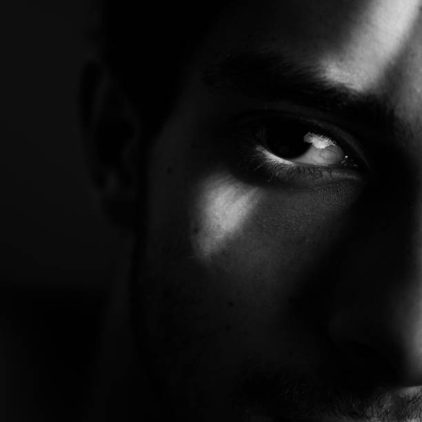 istock Shadows face light eye Black and white 1195246275