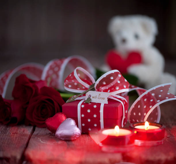 istock Valentine's Day Gift with Red Roses against a Wood Background 1195246489