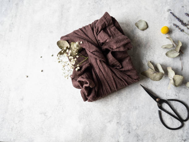 istock Eco-friendly fabric reusable gift packaging with Eucalyptus and white flowers. Romantic reusable sustainable gift wrapping alternative. Zero waste concept. 1195246685