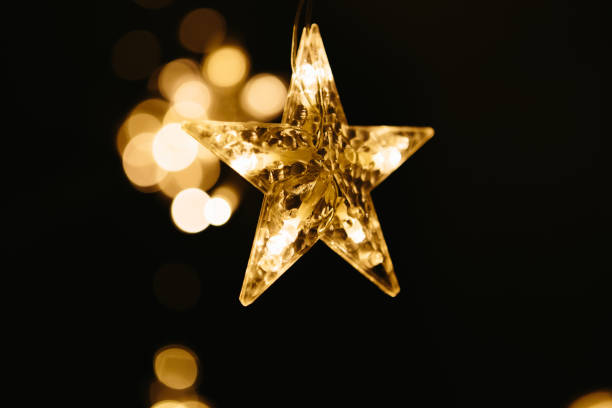 istock Christmas lights on dark background. Star shaped. 1195255806