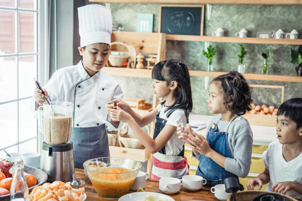 istock Childhood students and friends learning how to cooking in kitchen at school class 1195256764