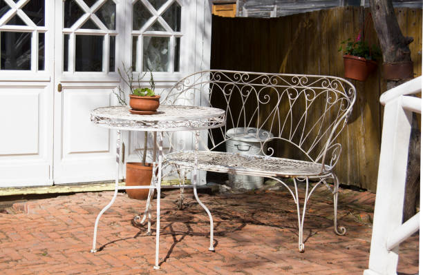 vintage wrought iron white table and chair in the courtyard of the museum of pastilles - pastilles imagens e fotografias de stock