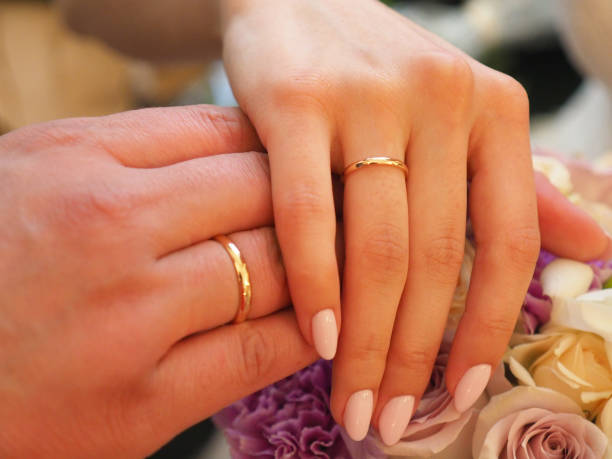 istock newlyweds hands with rings together closeup 1195256897