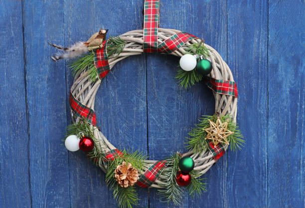 istock retro Christmas wreath on blue wall 1195258387