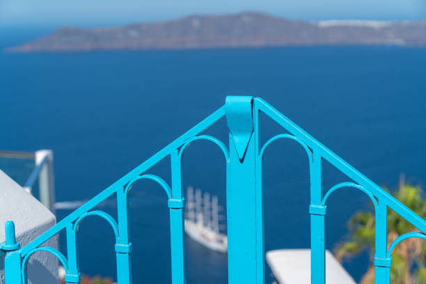 Bright blue barricade made of iron with defocused background with defocused background Mediterranean sea and Greek Islands,